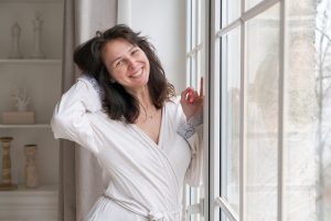 a woman in a robe smiling